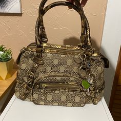 Beautiful Beige, Brown And Gold Faux Snakeskin Hand Bag. Charms Attached To Bag. All Charm Rhinestones Are Intact 11” W , 7” H 3 Zipper Pockets 3 Insert Pockets Unused- Tag Fell Off Gold Tote Satchel With Zipper Closure, Gold Crossbody Bag With Silver-tone Hardware, Gold Shoulder Bag With Silver-tone Hardware For Travel, Gold Satchel With Silver-tone Hardware And Top Handle, Gold Satchel With Silver-tone Hardware, Gold Crossbody Shoulder Bag With Silver-tone Hardware, Travel Satchel In Gold With Silver-tone Hardware, Travel Satchel With Silver-tone Hardware In Gold, Gold Satchel Bag With Silver-tone Hardware