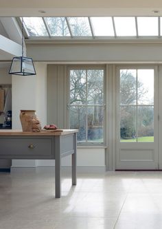 a kitchen with an island and two large glass doors leading to the outside patio area