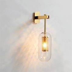 a light that is on the wall next to a glass jar with a light inside