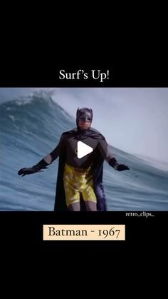 a man dressed as batman standing in front of a wave with the caption surf's up