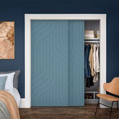 a bedroom with blue walls and an open closet door