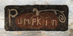 an embroidered patch with the word pumpkin on it and two small pumpkins in the center