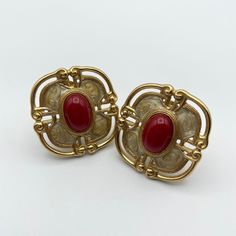 "Huge Etruscan Statement Earrings with Red Cabochon and Enamel Finish -Signed Monet -Gold tone finish with creamy enamel overlay and accent by a large red cabochon -Openwork Etruscan motif -Excellent vintage condition -Each measures approximately 1 5/16\" long x 1 1/4\" wide All jewelry purchases are tastefully wrapped in a chic gift box and adorned with ribbon - ready for gift giving. Holiday wrapping options are also available upon request. What is vintage? Vintage describes an item that is ov Red Enamel Clip-on Jewelry, Red Enamel Clip-on Earrings, Vintage Red Clip-on Earrings For Anniversary, Red Vintage Clip-on Earrings For Anniversary, Classic Red Cabochon Earrings, Classic Red Enamel Jewelry, Vintage Pierced Enamel Earrings, Red Enamel Vintage Earrings, Vintage Red Enamel Earrings