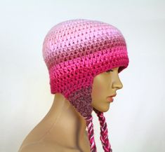 This cute pink hat is one of a kind. It has been crochet with two strands of yarn. This ensures that it is super thick and warm. It fades gracefully from light pink to darker shades. It has triangular ear flaps with tie-able tassels. One size fits most. Hand wash and lay flat to dry. Yarn may vary slightly from photo. Wear it and make a statement! Great for supporting your favorite cozy season! It has a lot of adorable charm . Great for back to school / fall ! One size fits most. For best result Pink Knitted Bonnet Cap, Adjustable Pink Bonnet Hat, Adjustable Pink Bonnet, Pink Crochet Yarn Hat, Cute Pink Knitted Hat, Pink Crochet Hat Made Of Yarn, Pink Hand Knitted Crochet Cap, Pink Knitted Crochet Yarn Hat, Pink Crochet Hat In Acrylic Yarn