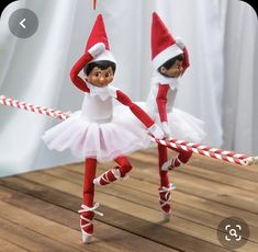 two elf dolls are playing with a rope