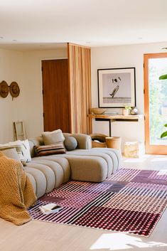 a living room filled with lots of furniture and decor on top of a hard wood floor