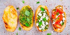 four different types of bread with toppings on them sitting next to eachother