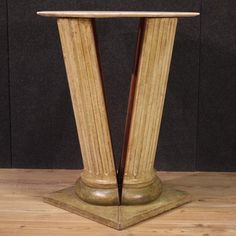 a wooden table with two columns on it