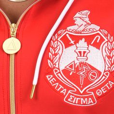 a person wearing a red jacket with an emblem on it