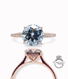 an engagement ring with a blue topazte and diamond band on the side, in rose gold