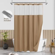 a bathroom with a tan and white shower curtain next to a bathtub in front of a wooden wall