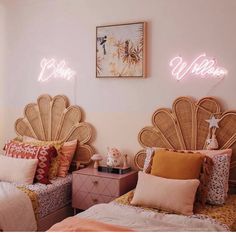 two twin beds with pink and orange pillows