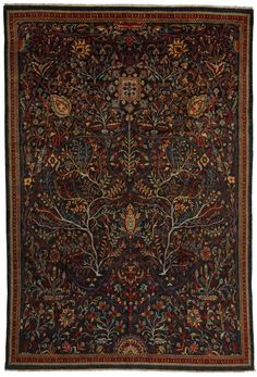 an antique rug with trees and flowers on it