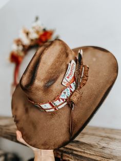 This burnt, distressed, felt fedora hat is a size 22 1/2 inches around.The hat band is an aztec and genuine leather band with a leather feather accent as well as a real feather and playing cards. This hat is burnt so it might have a slight smell for a few weeks.All feathers are glued to hold on the hat.FREE SHIPPING ON ALL OUR HAT ORDERS!All hats are branded by ©The Kiersten Zile CollectionNeed a Custom order? Message the Shop and we can start on that for you! Cowboy Hat Bands Alcohol, Custom Fedora Hat Ideas, Hat Burning Ideas, Burnt Hat, Burnt Hats, Cowboy Hat Band, Diy Hats, Custom Cowboy Hats, Brown Cowboy Hat