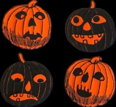 four pumpkins with faces painted on them