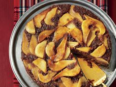 a pie with sliced apples on it sitting on top of a pan