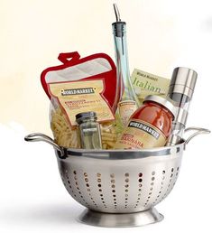 a silver colander filled with food and condiments