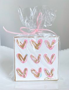 a white box with pink and gold hearts on it