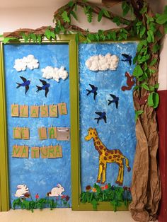 two doors decorated with paper mache and jungle animals, one painted blue the other green