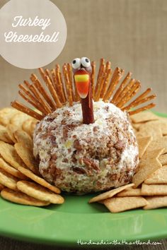 a turkey cheese ball sitting on top of a green plate