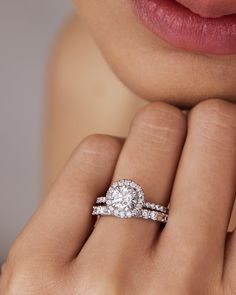 a woman's hand with a diamond ring on her finger