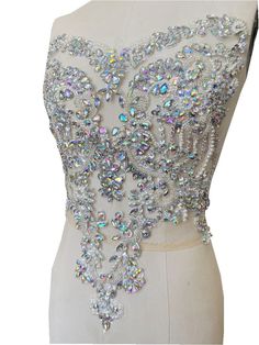 a white dress with lots of crystals on it