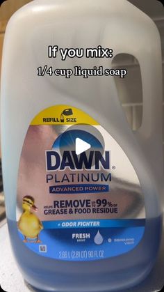 a gallon of dawn dish soap sitting on top of a counter next to a yellow rubber duck