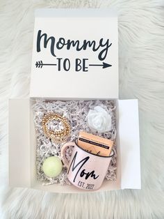 a mom's day gift box with a coffee mug and other items in it