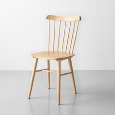 a wooden chair sitting on top of a white floor