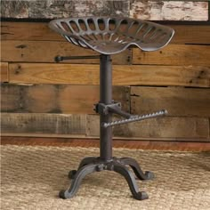 an old fashioned metal stool with a basket on it