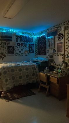 a bed room with a neatly made bed next to a night stand and blue lights