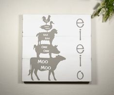 a sign that has animals on top of it and the words eief oom moo