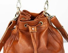 milloo products are handcrafted in Athens, Greece by a small team of artisans. The Danae Bucket bag can be worn as a crossbody or shoulder bag. Its roomy size allows you to take everything you need for a day while still looking elegant. Brown Soft Italian cowhide 12.5" X 11" X 5" (overall height X width X bottom depth") Cotton Floral Lining Brass Hardware YKK external zippers Short detachable handle Long detachable and adjustable strap 40" to 46" 2 external side zippered pockets Firm base 1 interior zip pocket 8" x 6" 2 internal slip pockets 6" x 6" 1 pen pocket Key clip attached to a long leather strip Zebra Sarasa, Frixion Pens, Pen Shop, Zipper Shorts, Crossbody Messenger Bag, Pen Case, Athens Greece, Zipper Wallet, Pen Sets