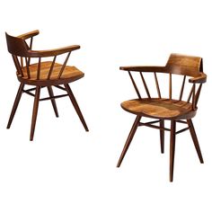 two wooden chairs sitting next to each other