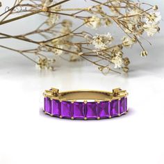 an image of a purple ring with flowers in the background