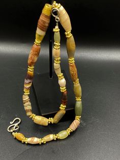 A Beautiful Jasper Beads Necklace from Ancient Roman's and Greeks times from Afghanistan Central Asia The Center Beads is slightly Gone From the Edges Sides folded in 18 karat gold The age of this beads are more than 2000 years Some Brass Gold Color Beads are Used as Spacers we provide fast and free shipping Enjoy Artisan Jasper Gemstone Beaded Necklace, Elegant Jasper Beaded Necklaces With Natural Stones, Elegant Jasper Beaded Necklace With Natural Stones, Artisan Jasper Beaded Necklaces With Round Beads, Polished Jasper Beaded Necklaces, Jasper Polished Round Beaded Necklaces, Jasper Beaded Necklaces With Polished Round Beads, Color Beads, Ancient Jewelry