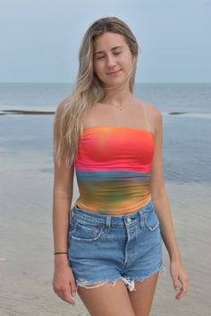 Paint your summer with vibrant hues in this eye-catching tube top, inspired by the breathtaking spectacle of sunrise. Here's why you'll radiate confidence in this top: Glowing Colors: Capture the essence of a sun-kissed morning with a palette of [insert specific colors, e.g., golden orange, fiery pink, soft coral]. Each shade seamlessly blends, mimicking the gradient of a rising sun. Flattering Fit: The classic tube top silhouette hugs your curves comfortably, while adjustable strapsensure a per Trendy Bandeau Tube Top For Beach Season, Trendy Strapless Tube Top For Beach Season, Strapless Tank Top For Vacation, Multicolor Tube Top For Beach In Spring, Multicolor Tube Top For Beach Spring Season, Summer Bandeau Top For Beachwear, Fitted Tube Top For Sunbathing In Summer, Fitted Tube Top For Summer Sunbathing, Trendy Tube Top For Summer Beach