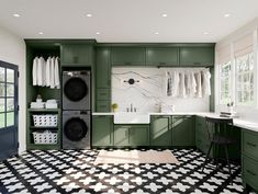 a laundry room with green cabinets and black and white tile flooring in the kitchen