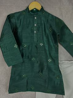 Boys Kurta Pajama Set in Soft Raw Silk Material with Cotton Pajama. The Kurta comes with embroidery and artificial mirror work. It has soft Cotton Lining. Item : Boys Kurta Pajama Ready to Wear : Yes Kurta Color : Bottle Green Pajama Color : White (Cotton) Fabric : Soft Raw Silk Pocket : Yes Lining (Yes/no) : Yes, a very soft cotton lining is attached with the Kurta. Disclaimer - There can be little variation in the color due to screen resolution setting, phone display setting or anything else. Festive Cotton Silk Sherwani With Embroidery, Traditional Cotton Silk Wear With Zari Work, Green Chikankari Embroidery Kurta In Raw Silk, Green Chanderi Sets With Chikankari Embroidery, Traditional Drape Cotton Silk Sets With Dori Work, Traditional Drape Sets With Dori Work In Cotton Silk, Embroidered Green Cotton Silk Kurta, Green Embroidered Cotton Silk Kurta, Embroidered Raw Silk Sherwani For Navratri