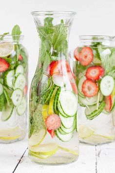 three glass vases filled with different types of fruit and veggies