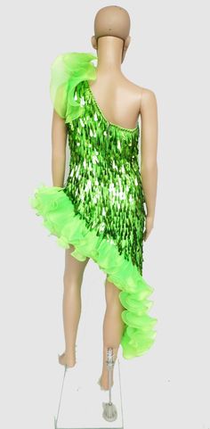 a mannequin wearing a green dress with sequins