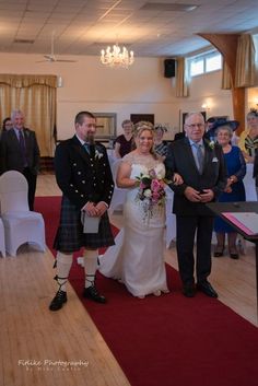 the bride and groom are walking down the aisle