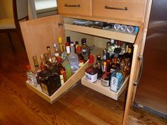 an open cabinet filled with bottles and liquor