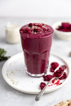 a smoothie with raspberry in it on a plate