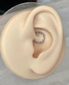 a close up view of a ring on top of a cake in the shape of an ear