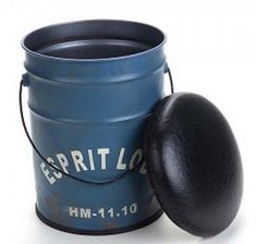 a blue pail with a black lid next to it