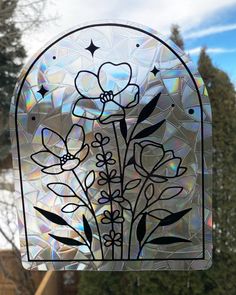 a stained glass window with flowers and stars in the center, on a sunny day