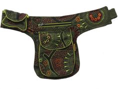 a green and red horse saddle with floral designs on the front, along with an orange flowered design