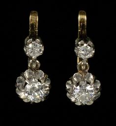 A splendid pair of French 18K gold platinum diamond earrings from Edwardian period C.1900. The earrings measure 12 mm high 6 mm wide. The diamonds are old European cut. The bottom ones measure 3.5 mm diameter or 0.15 Ct. The top diamonds are 2.5 mm or 0.15 Ct. The diamonds are set in platinum. The back of the earrings and the lever back clasps are 18K gold. The earrings are hallmarked with eagle - the French stamp for 18K gold. Platinum acid tested. Total weight is 2.9 grams. Excellent antique c Classic Evening Earrings With Single Cut Diamonds, Classic Gold Earrings With Rose Cut Diamonds, Formal Single Cut Diamond Drop Earrings, Classic Hallmarked Yellow Gold Diamond Earrings, Classic Hallmarked Diamond Earrings For Formal Occasions, Classic Hallmarked Diamond Earrings For Formal Events, Victorian Brilliant Cut Diamond Earrings For Anniversary, Victorian Diamond Earrings With Prong Setting For Anniversary, Vintage Yellow Gold Diamond Earrings With Rose Cut