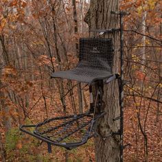 a hunting blind attached to a tree in the woods